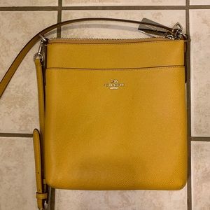 Mustard coach purse- never used